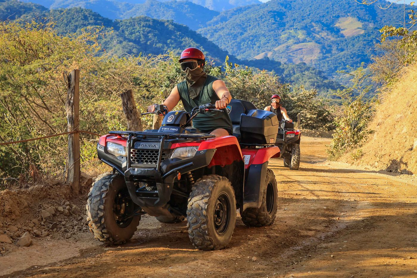 Guest enjoying a scenic stop beside the river during a Honda ATV adventure tour.