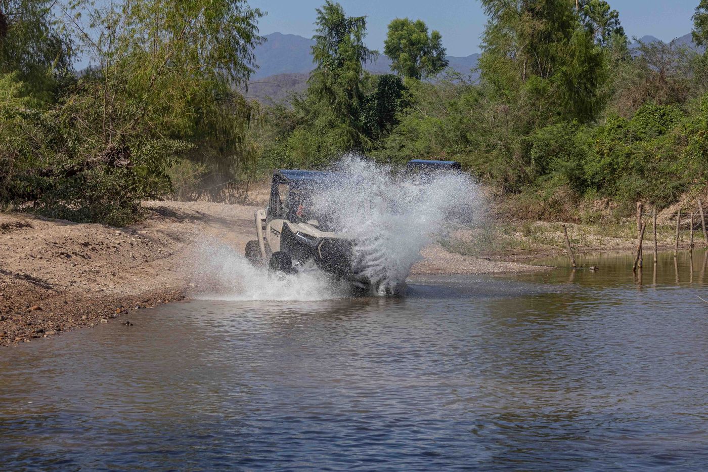 RZR splashing through a river on an off-road adventure in Nayarit