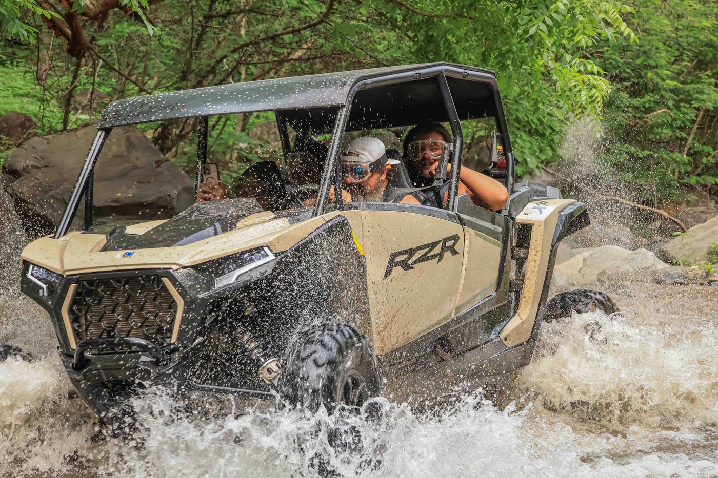 Family crossing a river on the best RZR tour in Nayarit