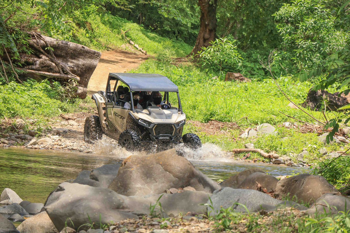 UTV tour crossing a river surrounded by nature in Nayarit