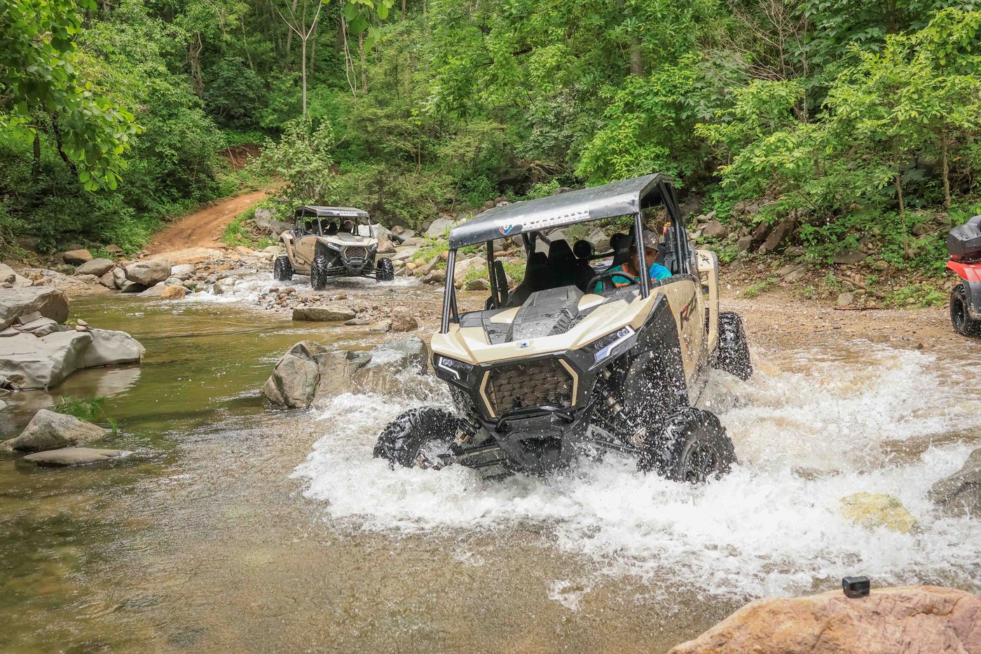 RZR crossing a river through the jungle during the Capomo Route tour in Nayarit
