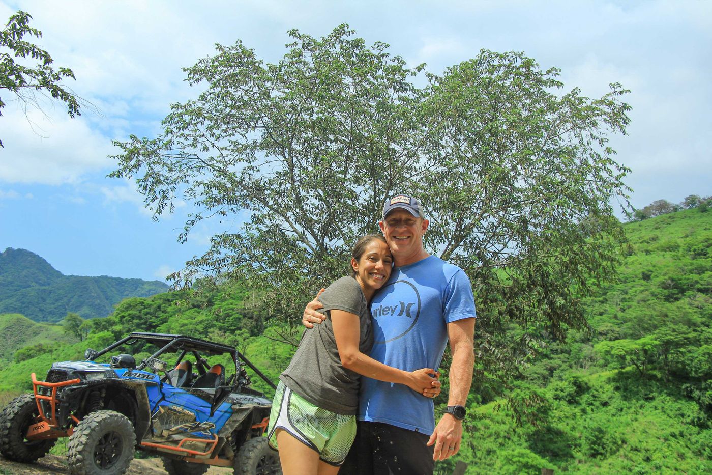 Couple enjoying a Polaris RZR adventure with scenic mountain views in Puerto Vallarta
