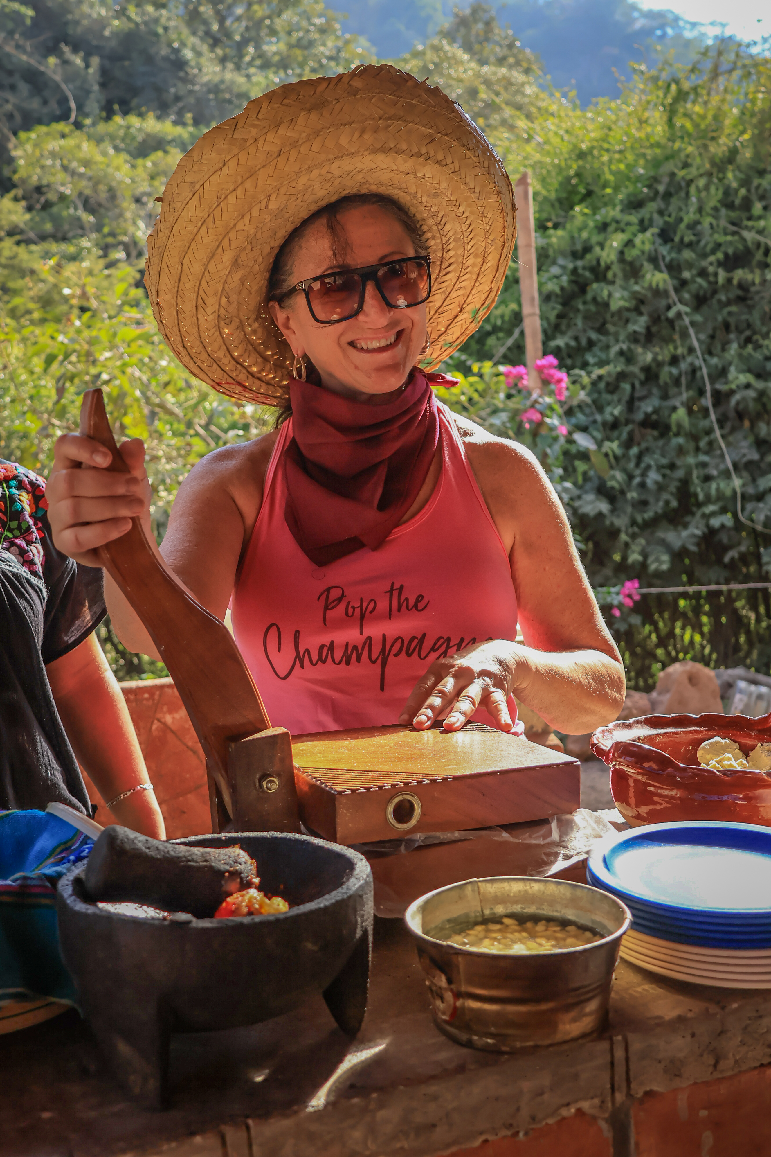 Guest making handmade tortillas as part of the local cultural experience.
